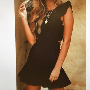 Flouncy black open back mini dress